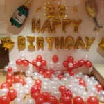 Gold balloon birthday decoration at home with red and white balloons