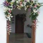 White and pastel floral arch decoration for house entrance