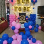 Mom to be balloon decoration setup at home with lights and backdrop