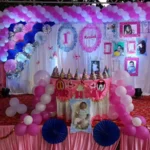 Pink and white balloon birthday decoration with customized backdrop