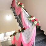 Pink fabric and flower staircase decoration for housewarming